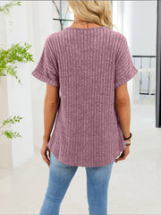 Ribbed knit short sleeve t-shirt in dusty blue with a curved hem and decorative buttons.