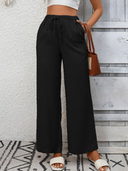 Black high-waist wide-leg pants with drawstring and pockets.