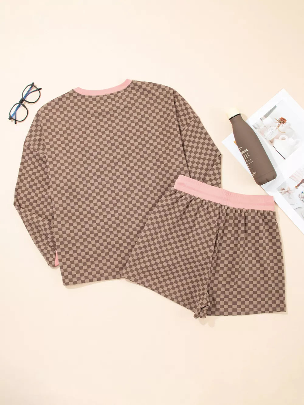 Camel checkerboard loungewear set with pink trim, includes long sleeve top and shorts.
