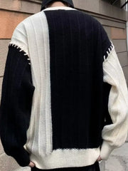 Oversized black and white color block sweater with contrast stitching detail.