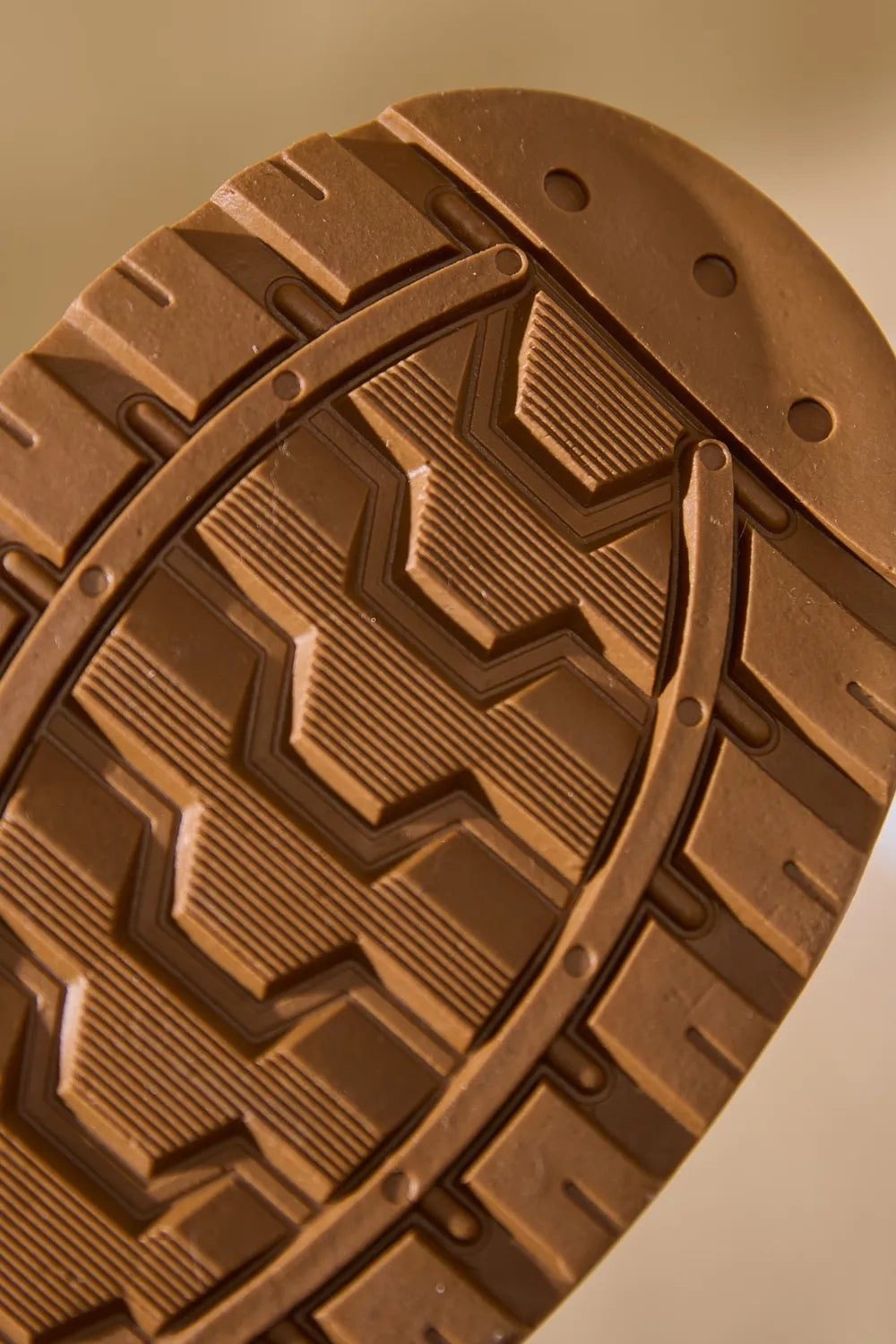 Suede house slippers sole detail in caramel brown with deep tread pattern.