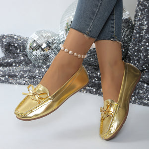 Gold bow embellished flat slip-on loafers with a square toe.