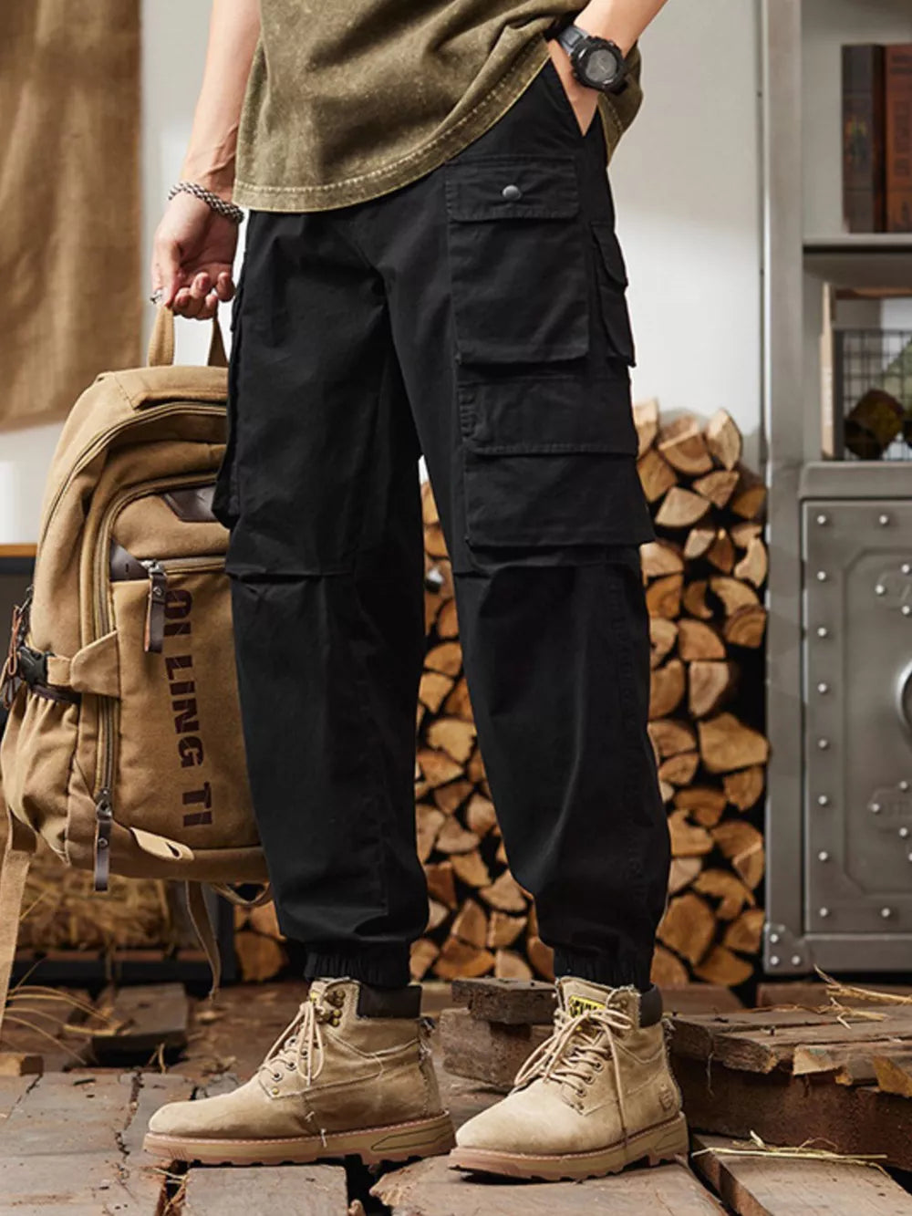 Black relaxed fit cargo pants with multiple pockets and elastic cuffs.