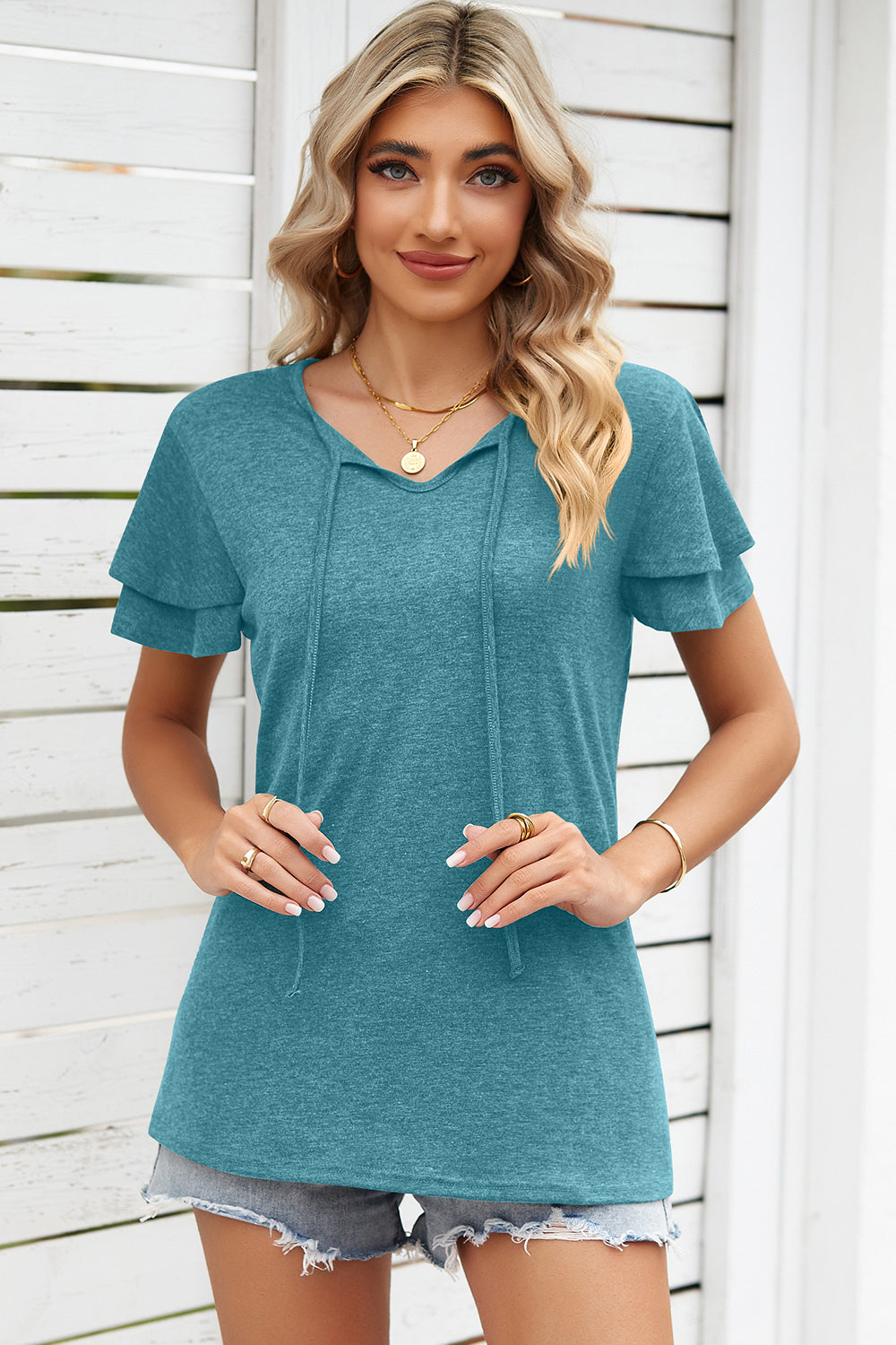 Turquoise flutter sleeve henley tee with tie neck detail and layered sleeves.