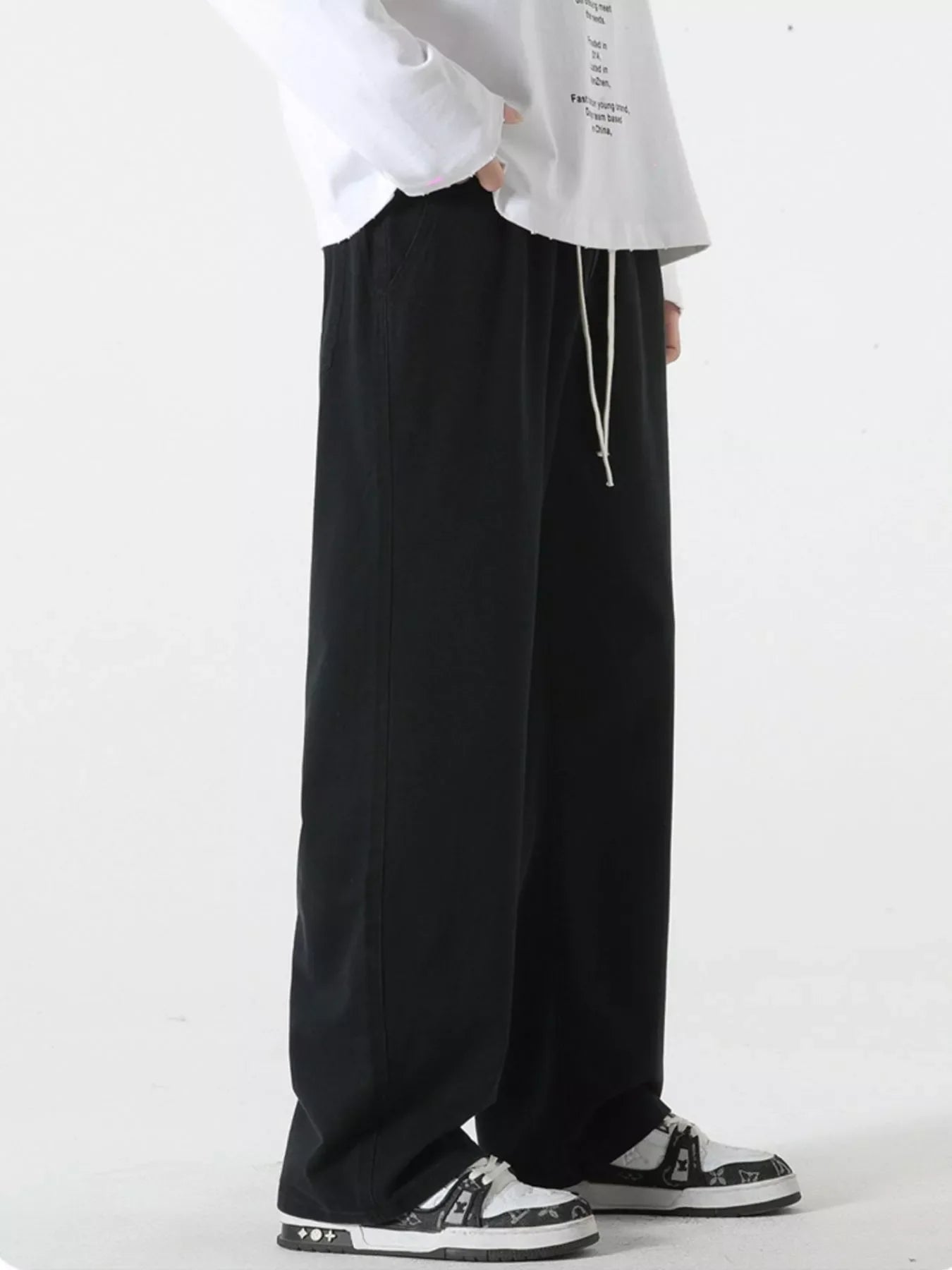 Black relaxed fit drawstring pants with a white drawstring detail.