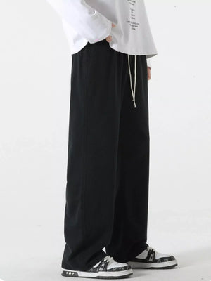 Black relaxed fit drawstring pants with a white drawstring detail.