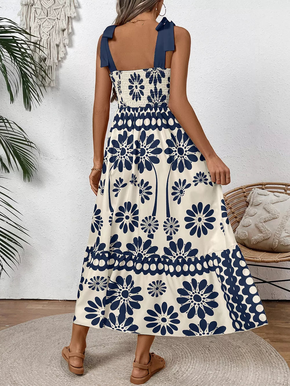 Charming floral midi dress in dark blue with tie shoulders and smocked bodice.