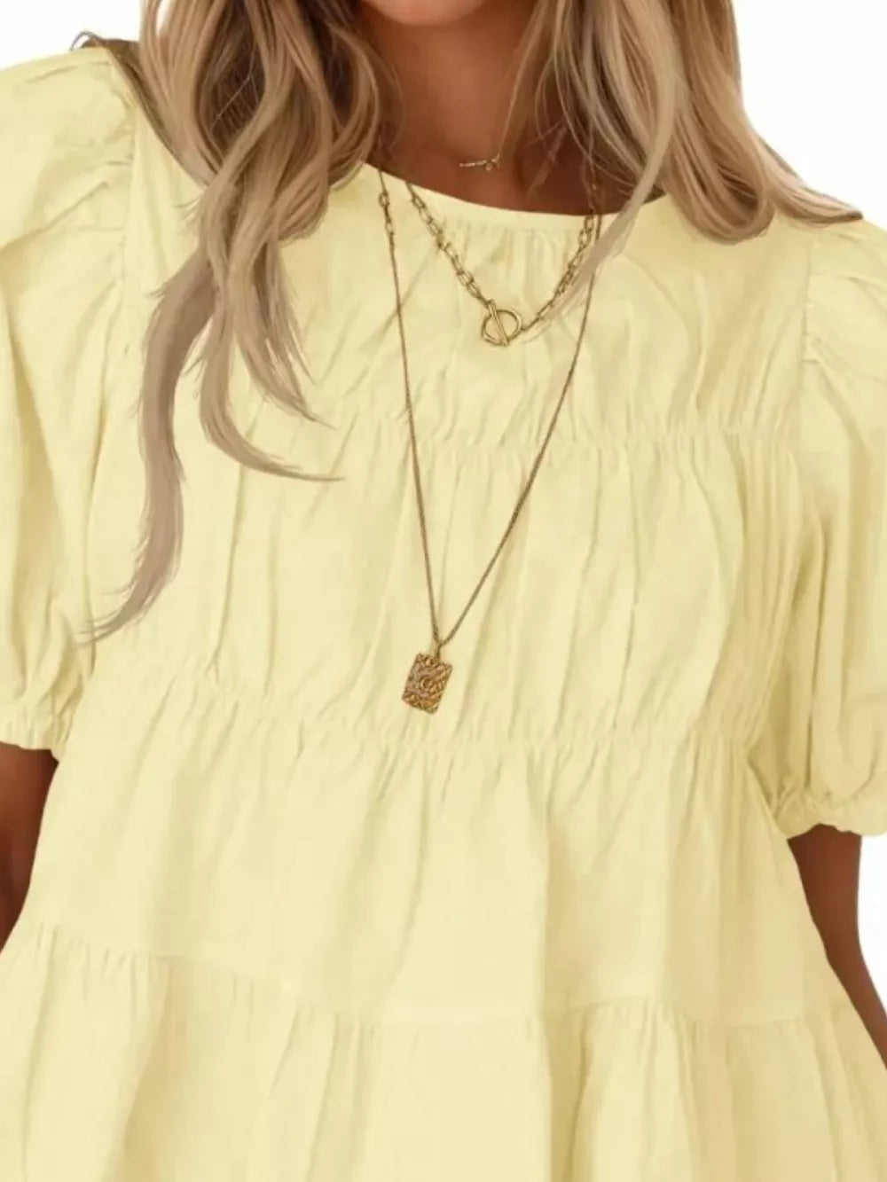 Light yellow maternity blouse with puff sleeves, ruffled tiers, and smocked bodice.