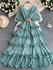 Green polka dot tiered midi dress with puff sleeves and a woven belt.