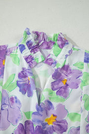 Vibrant floral mini dress with ruffled collar and V-neck detail.