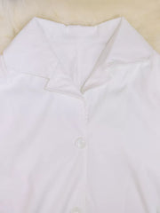 White midi dress with lapel collar and button front detail.
