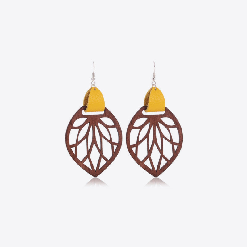 Leaf cutout wood dangle earrings with yellow leather accent.
