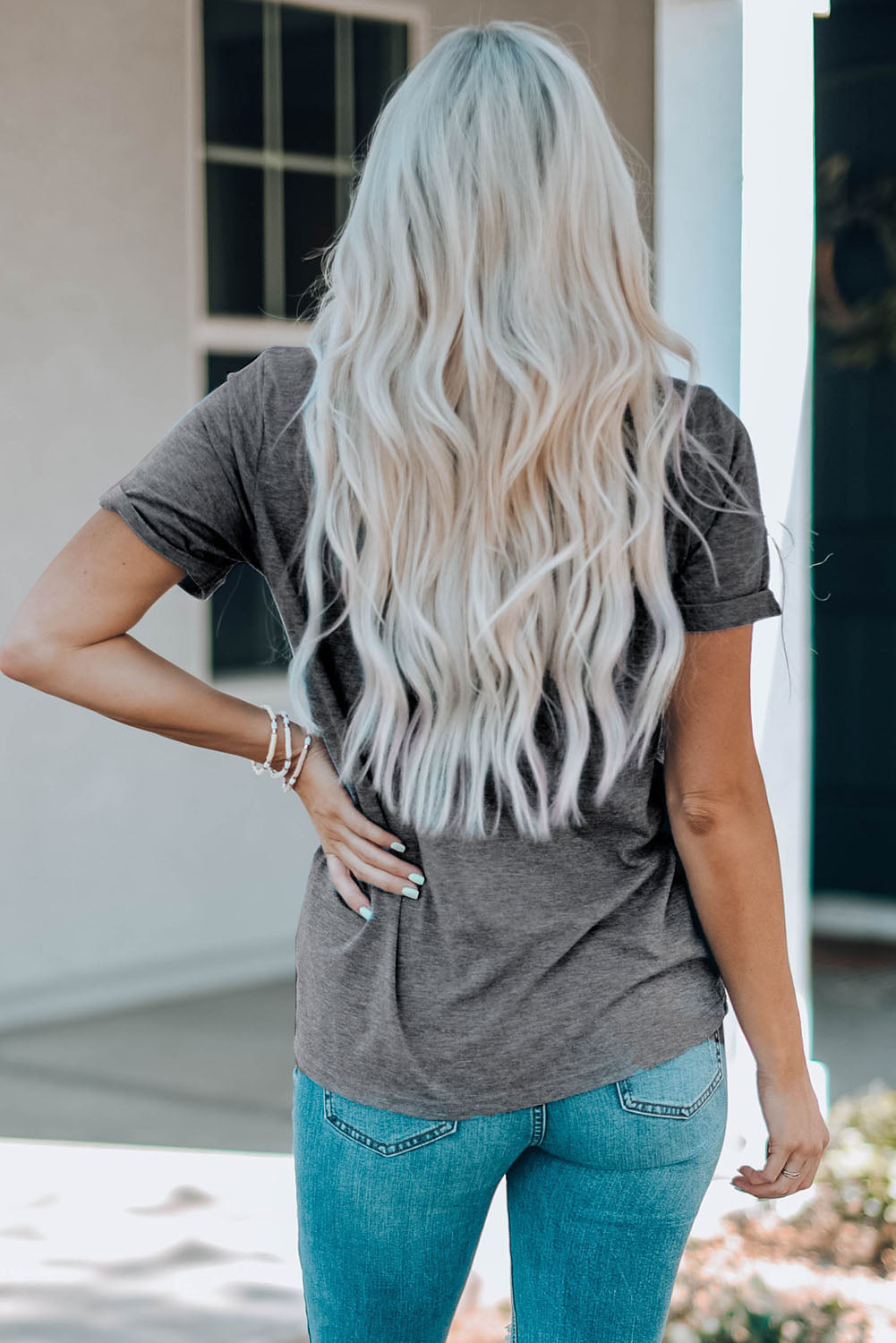 Gray graphic tee with short sleeves and a crew neck, paired with blue jeans.
