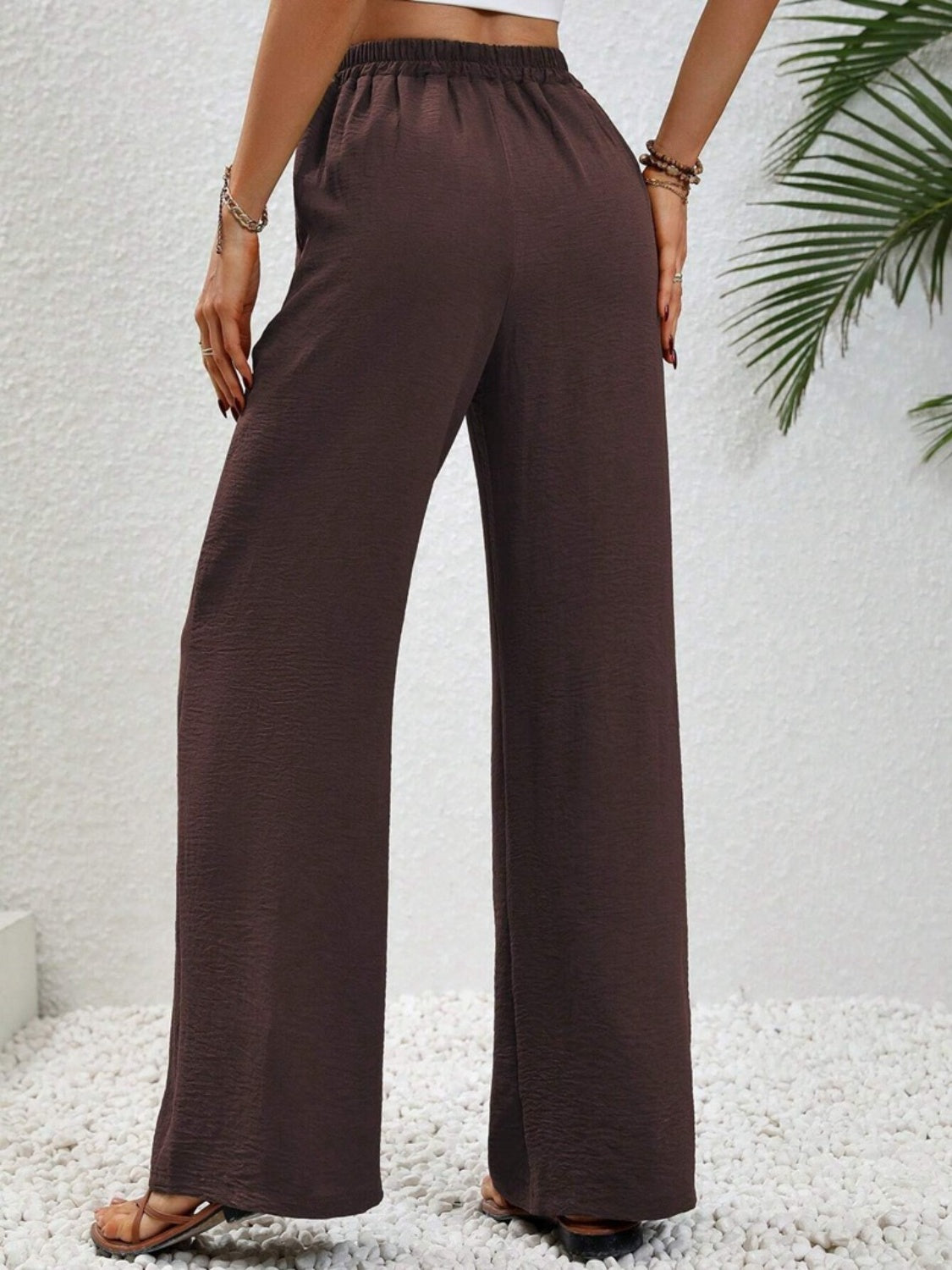 Textured palazzo trousers in dark brown with a drawstring waist and wide legs.