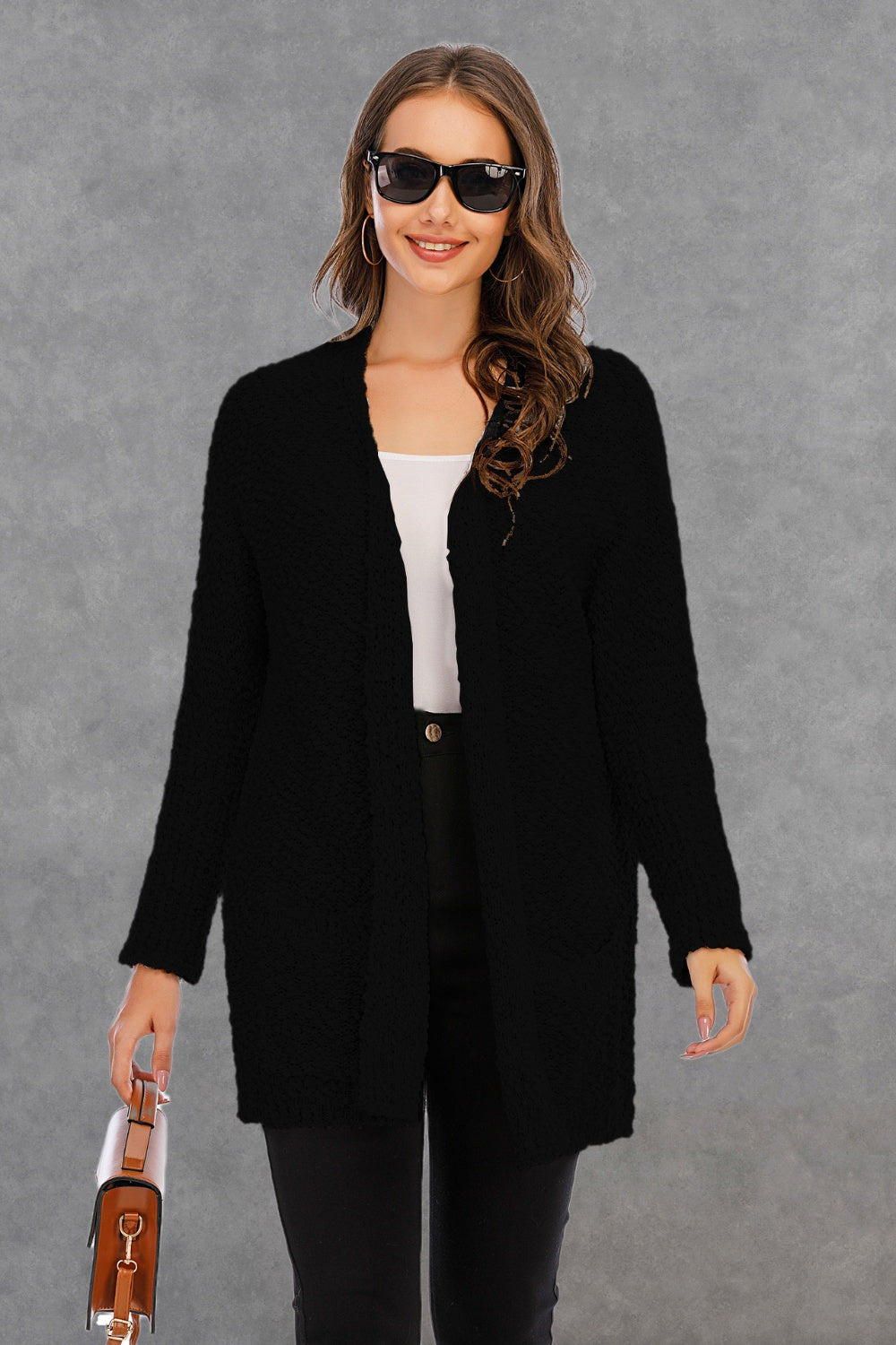 Black textured cocoon cardigan with patch pockets and open front.