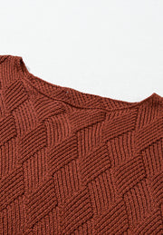 Textured diamond knit sweater in rust acrylic with a relaxed fit and crew neck.