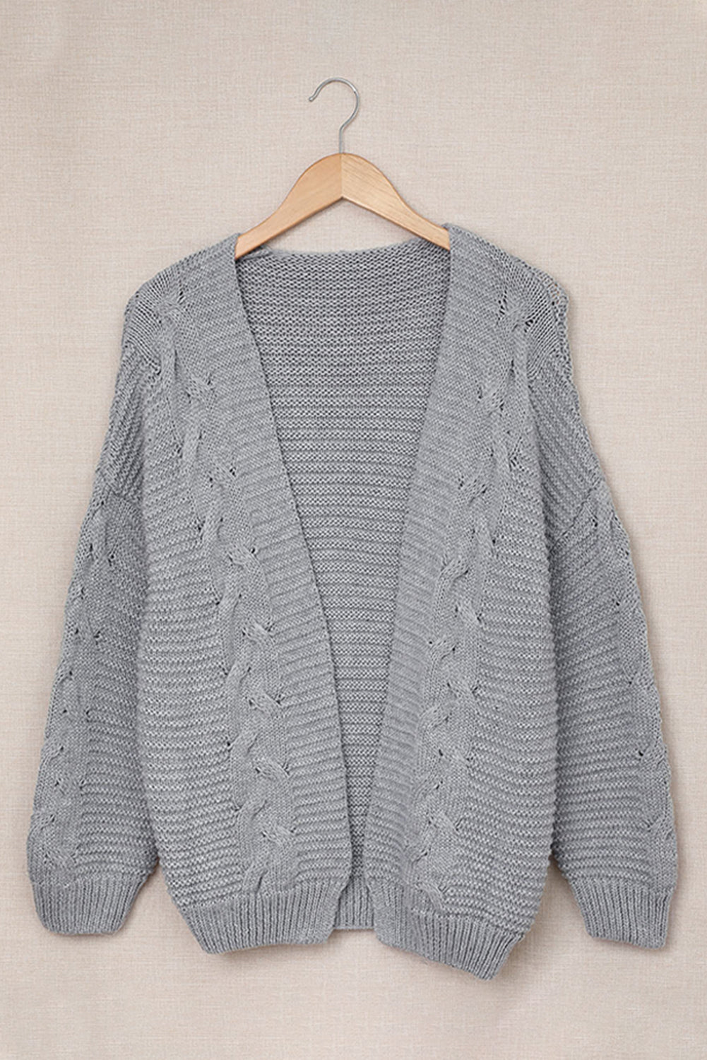 Gray acrylic cable knit open-front cocoon cardigan with wide sleeves and ribbed trim.