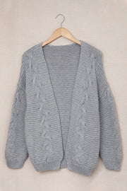 Gray acrylic cable knit open-front cocoon cardigan with wide sleeves and ribbed trim.