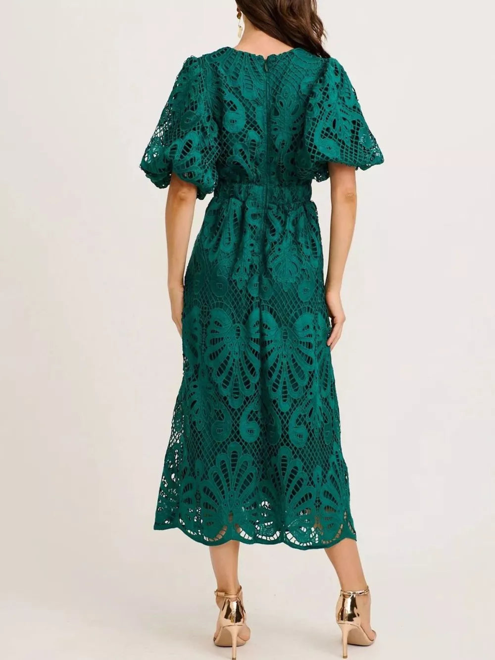 Green lace midi dress with puff sleeves and cinched waist, featuring intricate openwork.