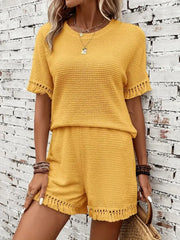 Yellow textured knit set with fringe detail on short sleeves and hem.