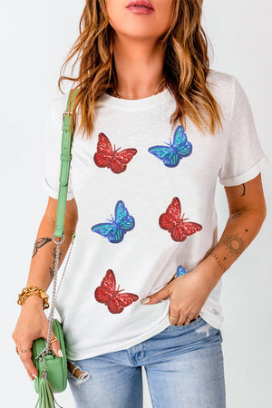 White t-shirt with embroidered red and blue butterfly motifs.