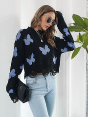 Black cropped knit sweater with distressed hem and light blue butterfly print.