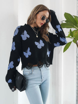 Black cropped knit sweater with distressed hem and light blue butterfly print.
