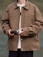 Oversized camel brown casual snap jacket with buttoned chest pockets and collar.