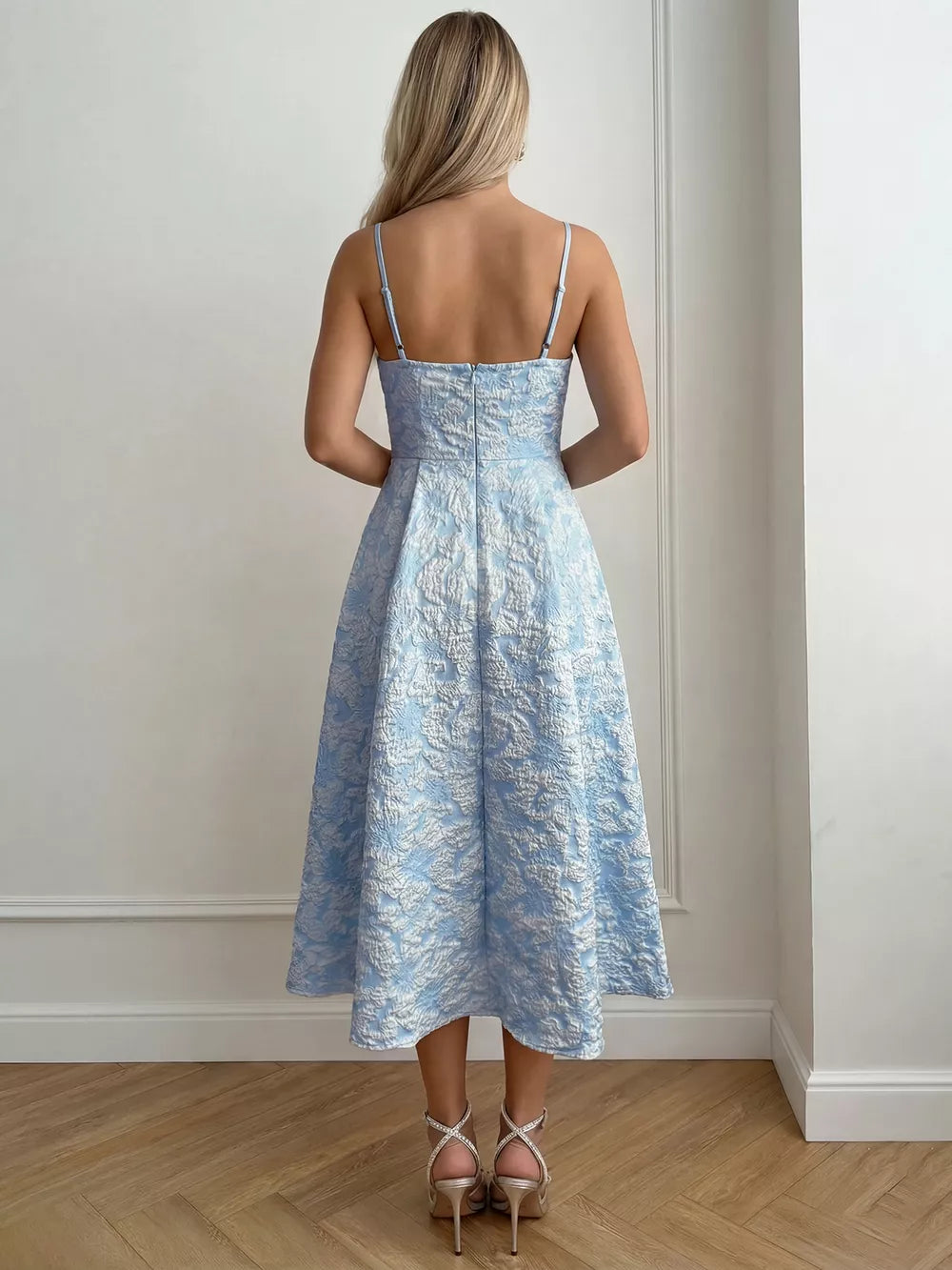 Light blue textured floral a-line midi gown with spaghetti straps and a full skirt.