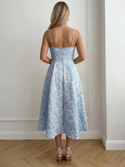 Light blue textured floral a-line midi gown with spaghetti straps and a full skirt.