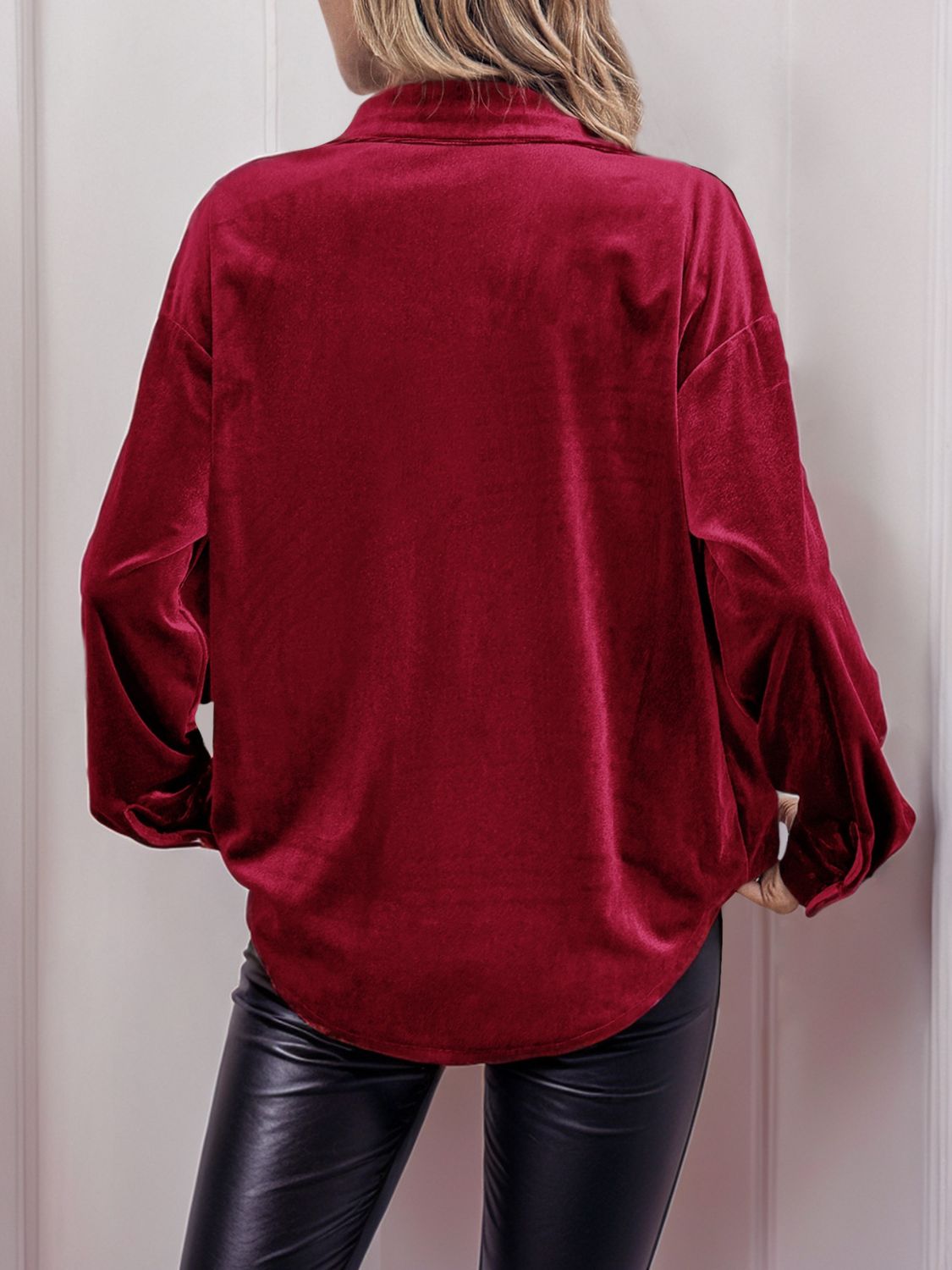 Burgundy velvet blouse with blouson sleeves and button-up detail.