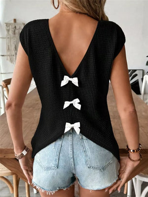 Black waffle knit V-neck shirt with cap sleeves and three white bow details down the back.