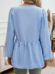 Sky blue striped peplum blouse with puff sleeves and a keyhole neckline.