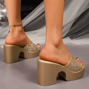 Gold open-toe block heel sandals with glitter straps and platform sole.