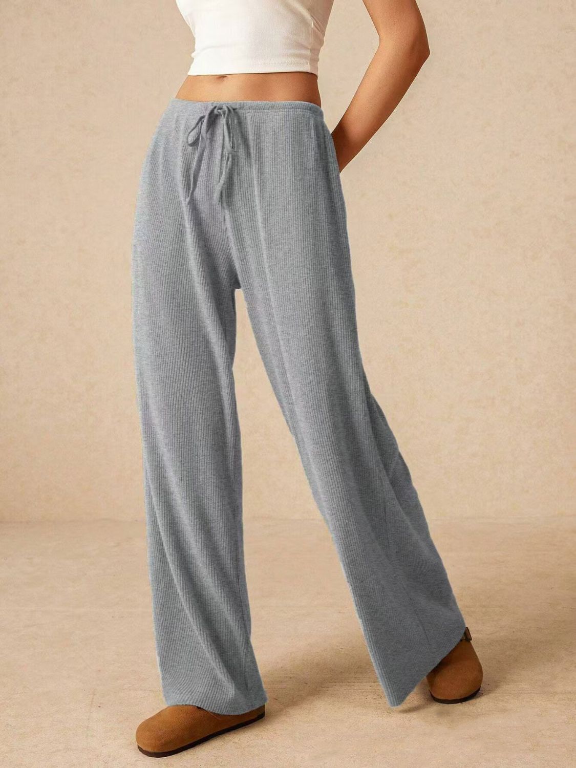 Gray ribbed cotton palazzo lounge trousers with drawstring waist and wide leg.