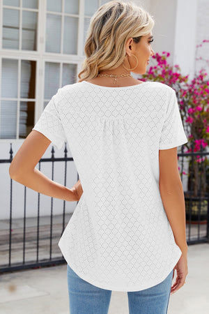 White eyelet yoke gathered henley shirt with short sleeves and a curved hem.
