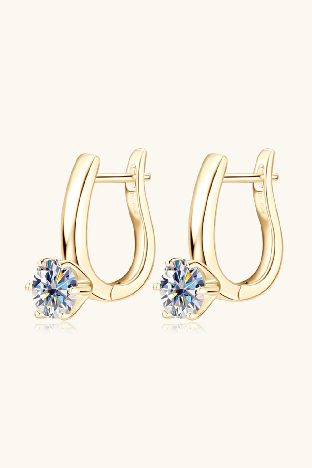 Gold solitaire huggie hoop earrings with clear cubic zirconia stones.