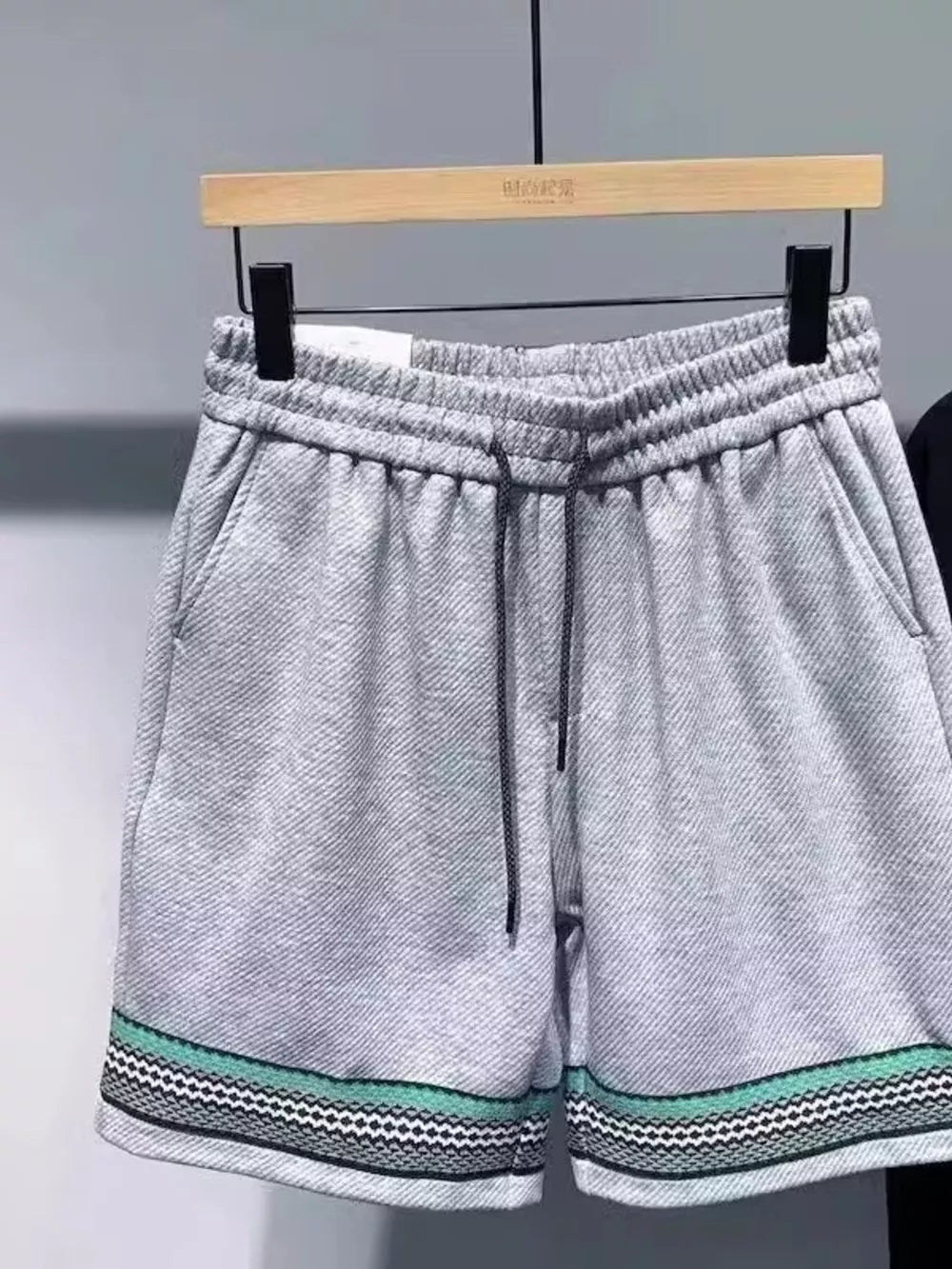 Gray drawstring shorts with pockets and patterned trim