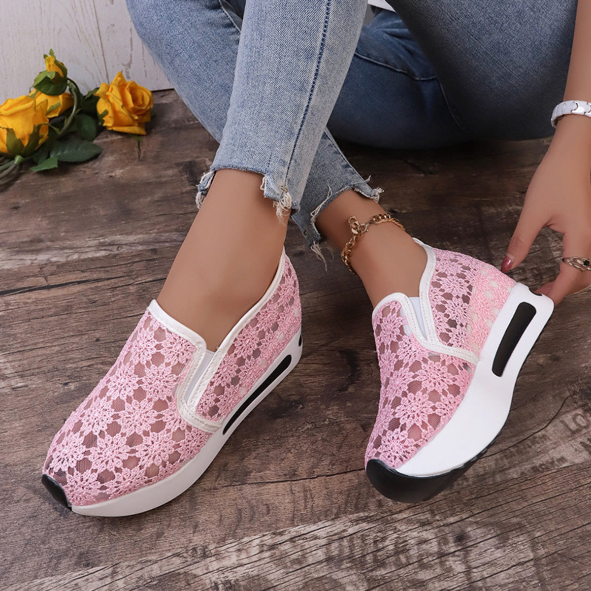 Pink floral lace slip-on sneakers with white trim and a chunky sole.