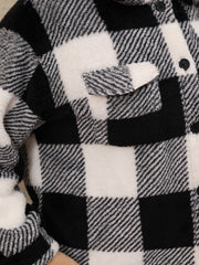 Black and white plaid shacket with fluffy texture and chest pocket.