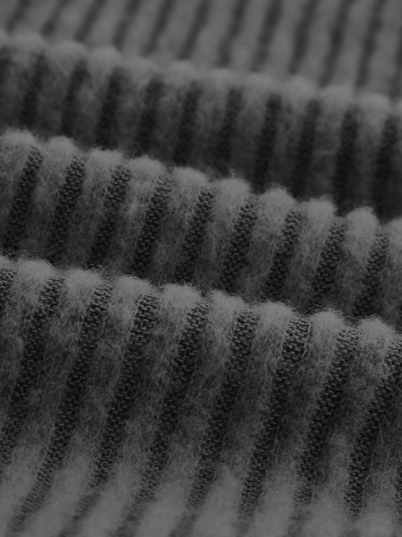 Dark gray ribbed knit top with a soft, fuzzy texture.
