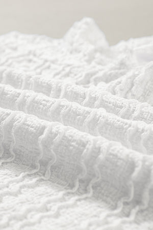 White textured long sleeve blouse with ruffle trim detail