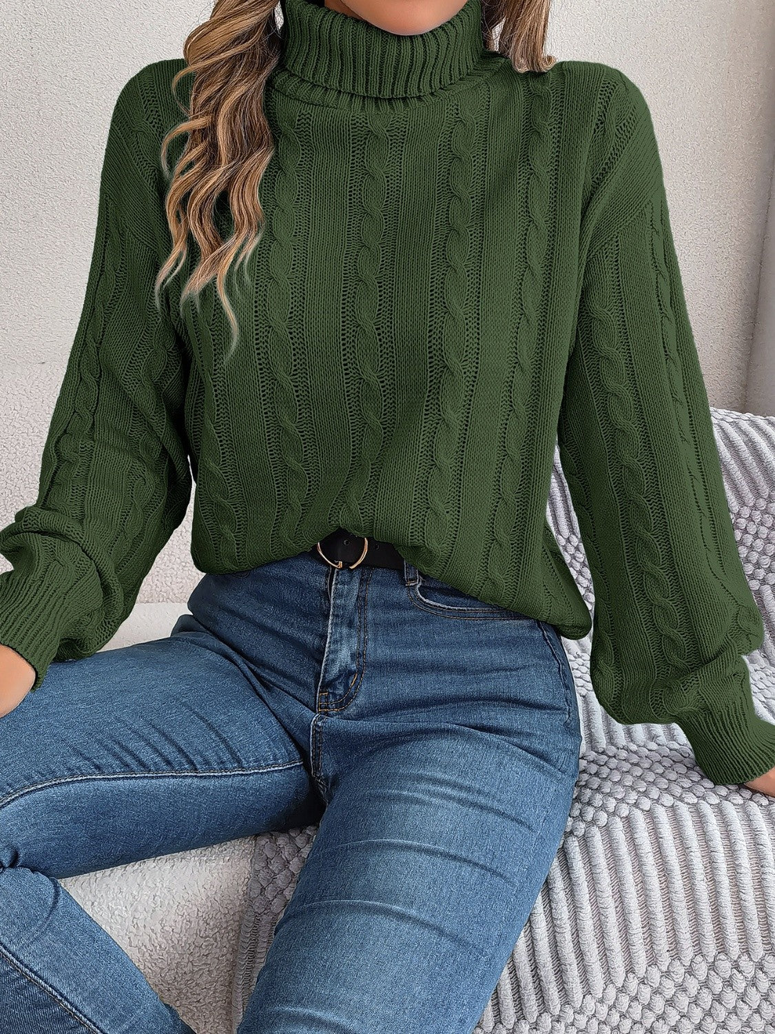 Dark green cable knit turtleneck sweater with voluminous sleeves