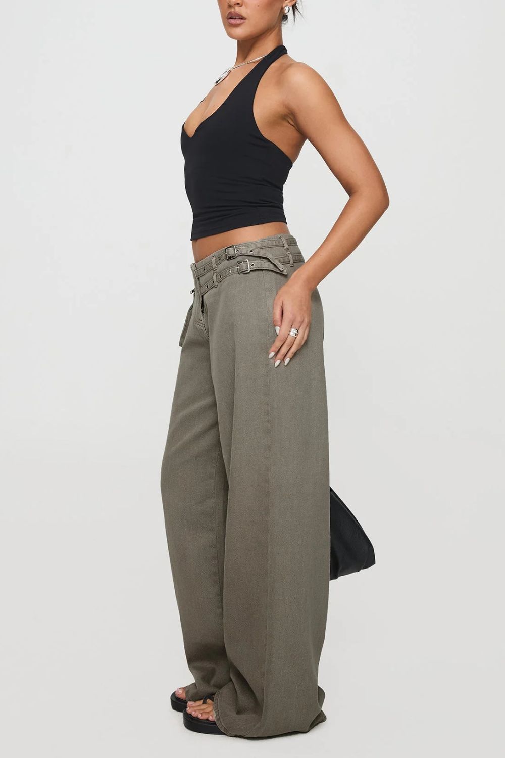 Utility buckle flared denim trousers in dark gray with double buckle detail and wide leg.