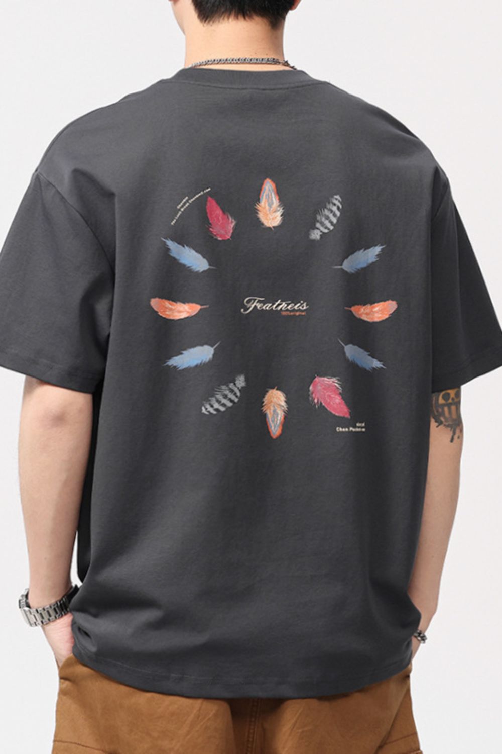 Men's dark gray cotton blend crew neck t-shirt with a circular feather print and text.