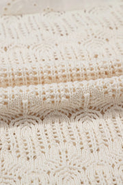 Beige crochet knit vest with eyelet yoke detail and open knit pattern.