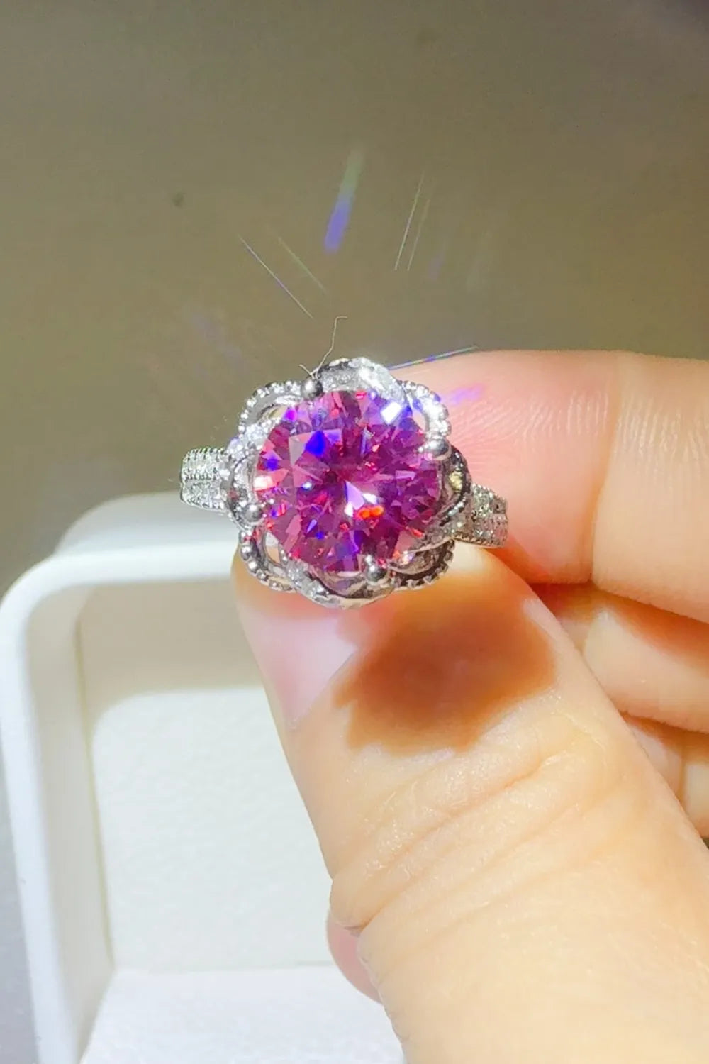 Crimson Bloom moissanite halo ring in cerise with a floral setting and diamond band.