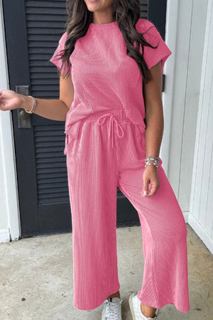 Fuchsia pink ribbed knit drawstring co-ord set with short sleeves and wide-leg pants.