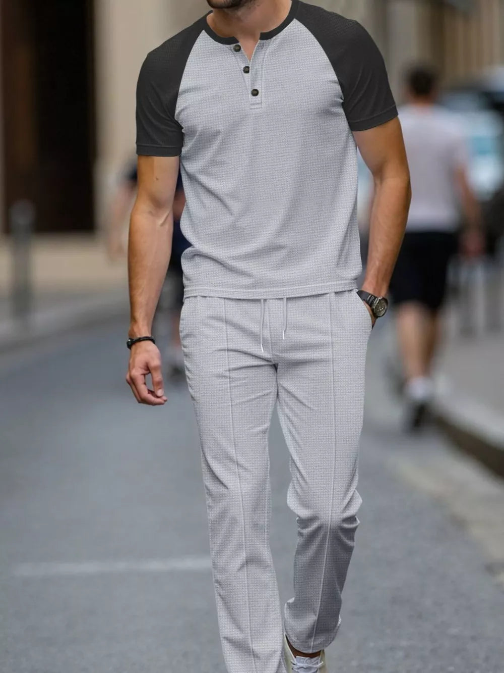 Men's grey two-piece loungewear set with a patterned henley shirt and drawstring pants.