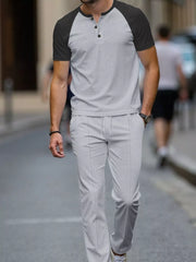 Men's grey two-piece loungewear set with a patterned henley shirt and drawstring pants.